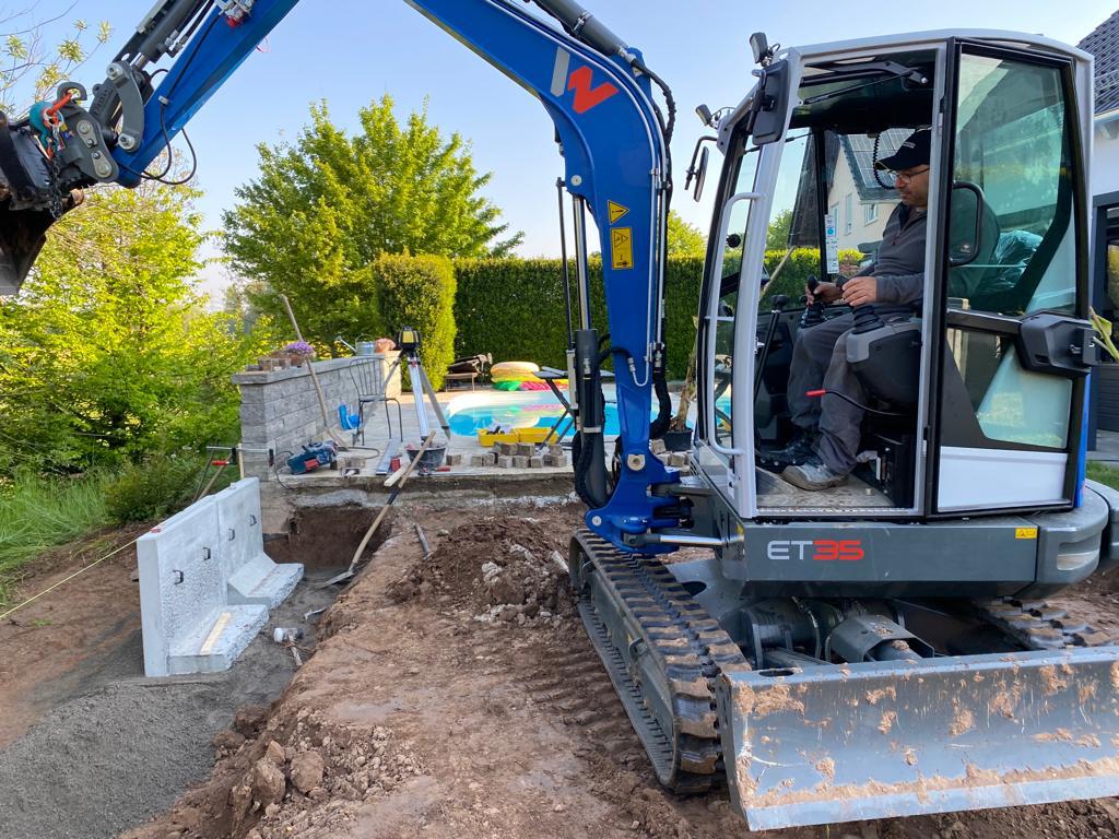 setzen von Betonelementen mit Bagger